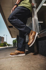 Men's Reclaimer wedge waterproof work boots in pyramid sand color by CAT worn view